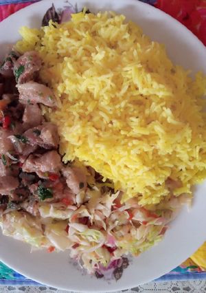A picture of Tumeric rice with cabbage and pork.