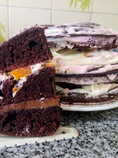Una foto de Torta de chocolate, crema, dulce de leche y duraznos