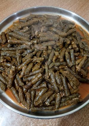 A picture of Stuffed Grape Leaves with Meat and Tomato Sauce.