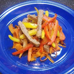 A picture of Pepper steak with "Coodles" aka carrot noodles.