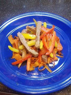 A picture of Pepper steak with "Coodles" aka carrot noodles.