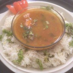 A picture of Tomato rasam with rice.