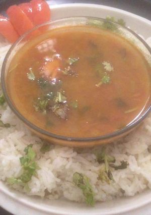 A picture of Tomato rasam with rice.