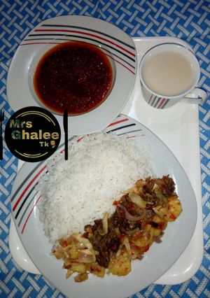 A picture of Rice and stew with irish sauce and pap.