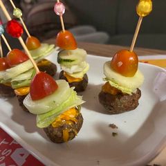 A picture of Cheeseburger bites on a stick.