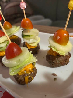 A picture of Cheeseburger bites on a stick.