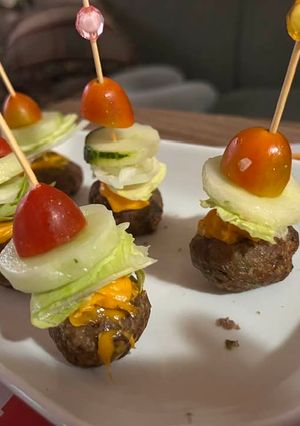 A picture of Cheeseburger bites on a stick.