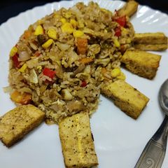 A picture of Thai style fried rice with vegetables and tofu.