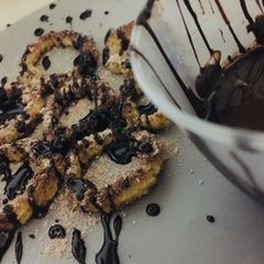 A picture of Baked churros with chocolate sauce.