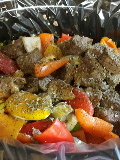 A picture of Beef tips with onions and sweet peppers.