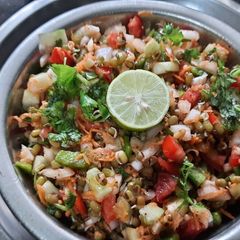 A picture of Whole Green Moong sprouts vegetables salad.