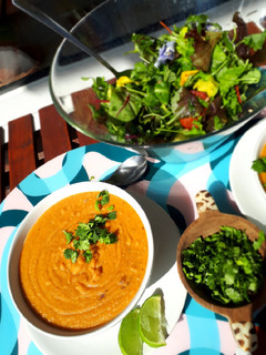 A picture of Spicy red lentil soup with onion and coriander.