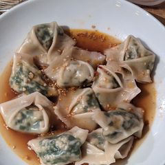 A picture of Tofu Garlic Chive Dumplings in Chili Broth.