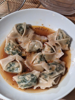A picture of Tofu Garlic Chive Dumplings in Chili Broth.