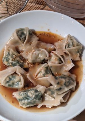 A picture of Tofu Garlic Chive Dumplings in Chili Broth.