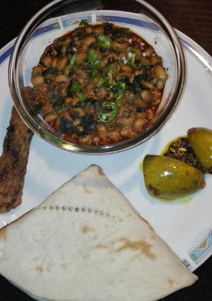 A picture of White Lobia With Roti Homemade Achar and Seekh Kabab.