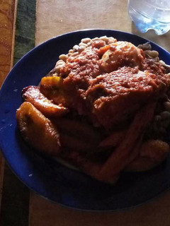A picture of Beans with fried plantain and sauce.