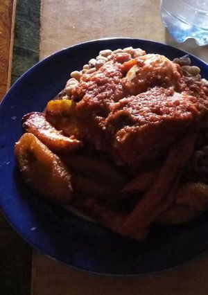 A picture of Beans with fried plantain and sauce.