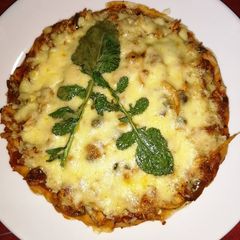 A picture of Stove Top Chicken Tikka Pizza.