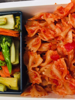 A picture of Pasta with cheese-tomato herb sauce & stir fry vegetables.