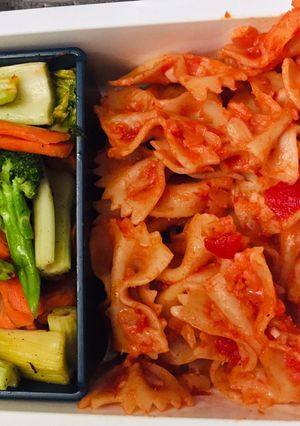 A picture of Pasta with cheese-tomato herb sauce & stir fry vegetables.