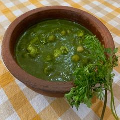 A picture of Palak Chana Paneer (spinach chickpea cottage cheese gravy).