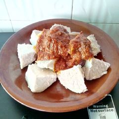 A picture of Cocoyam with palm oil stew.