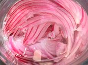 A picture of pickled red onions