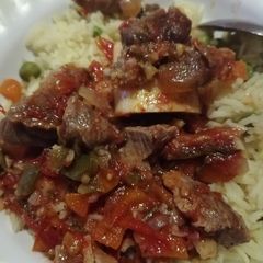A picture of Cooked red meat with rice.