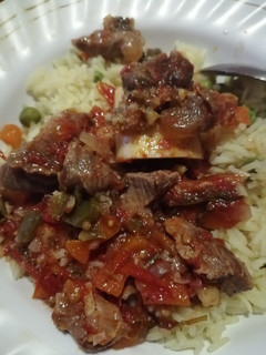A picture of Cooked red meat with rice.