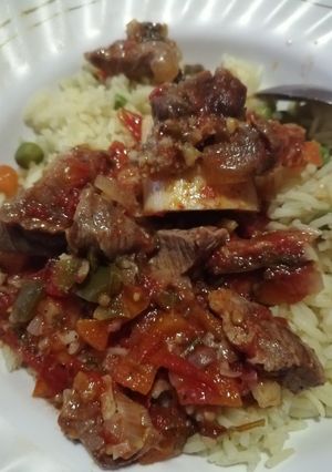 A picture of Cooked red meat with rice.