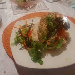 A picture of Pita bread with chicken strips.. mayonaisse and Wasabi spread.