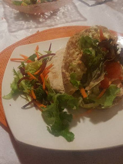 A picture of Pita bread with chicken strips.. mayonaisse and Wasabi spread.