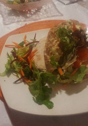 A picture of Pita bread with chicken strips.. mayonaisse and Wasabi spread.