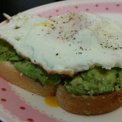 A picture of Avocado toast with fried egg.