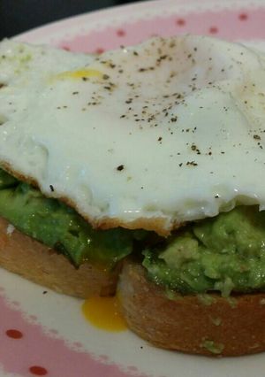 A picture of Avocado toast with fried egg.
