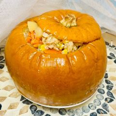 A picture of Tender chicken with vegetables in pumpkin.