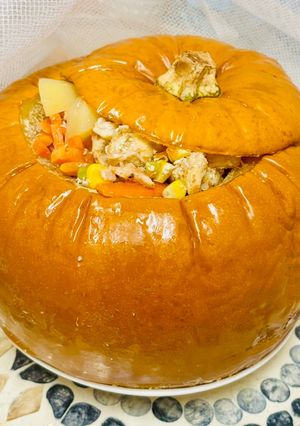 A picture of Tender chicken with vegetables in pumpkin.