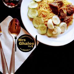 Jollof sphagetti with fried meat and cucumber and eggs and coke A picture of Jollof sphagetti with fried meat and cucumber and eggs and coke.