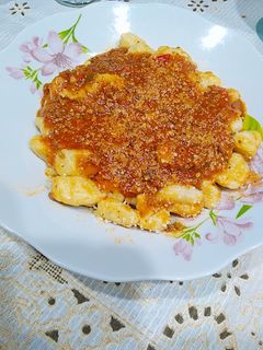 Una foto de Ñoquis de papa con salsa bolognesa