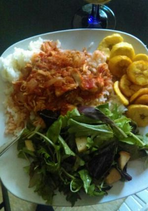 A picture of Boiled rice, Fried eggs, Fried plantains with apple salad dressing.