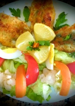 A picture of Sardine fritters with green salad.