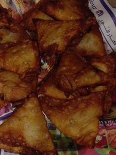 A picture of Chicken samosa and roll.