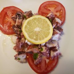 A picture of Octopus and tomato salad.