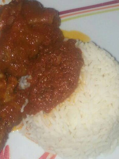 A picture of Cowleg & chicken stew with white rice.