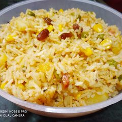 A picture of Brown Rice with lots of veggis.