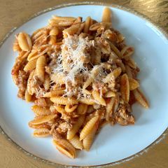 A picture of Malloreddus alla Campidanese (pasta with saffron, tomato and pork sausage ragù).