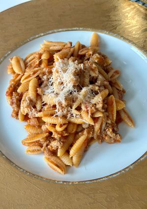 A picture of Malloreddus alla Campidanese (pasta with saffron, tomato and pork sausage ragù).