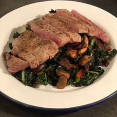 A picture of Steak with cavolo nero and chestnut mushrooms.