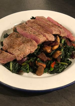 A picture of Steak with cavolo nero and chestnut mushrooms.